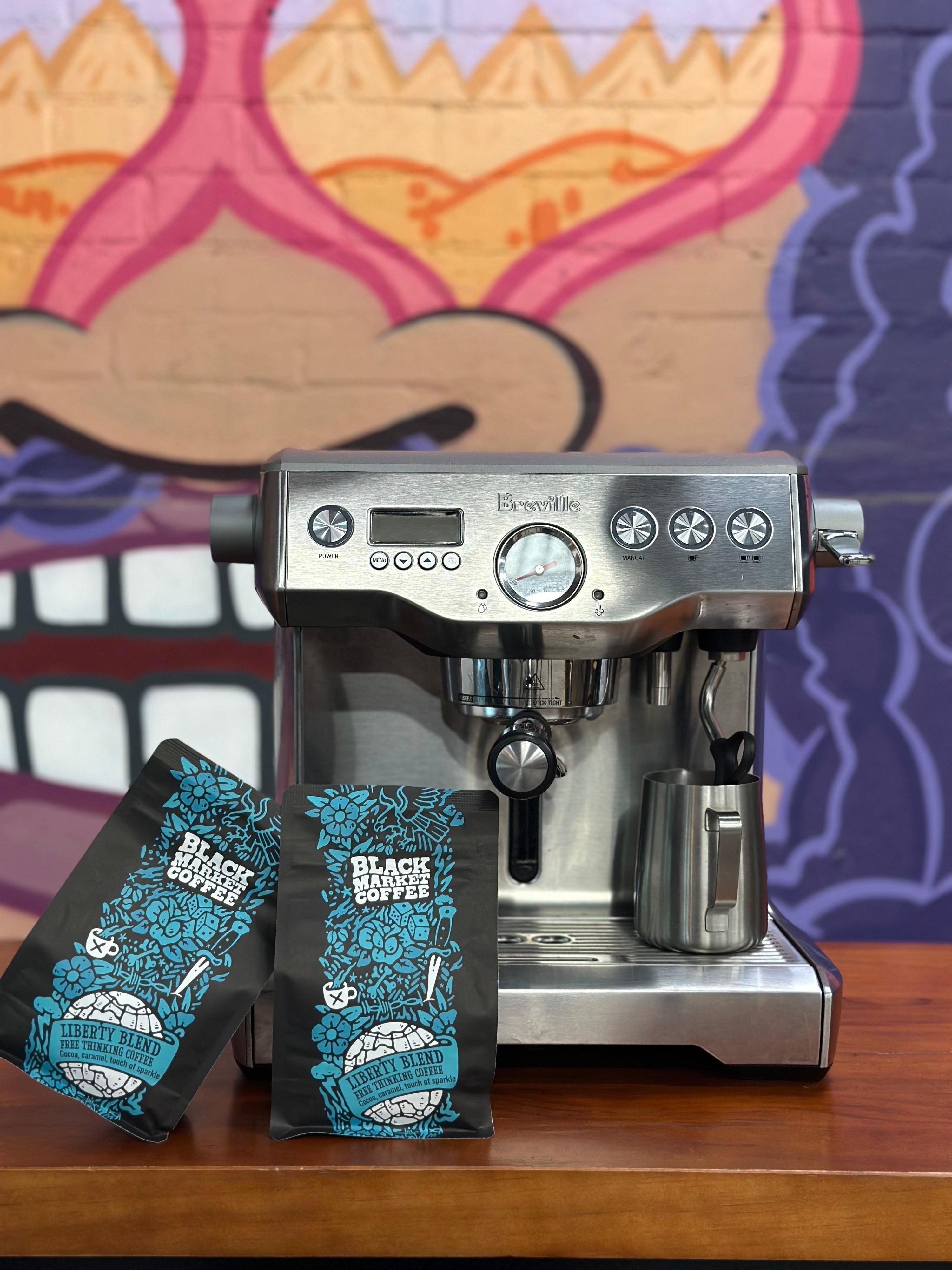Breville espresso machine on a kitchen bench with freshly ground coffee — Black Market Coffee Australia