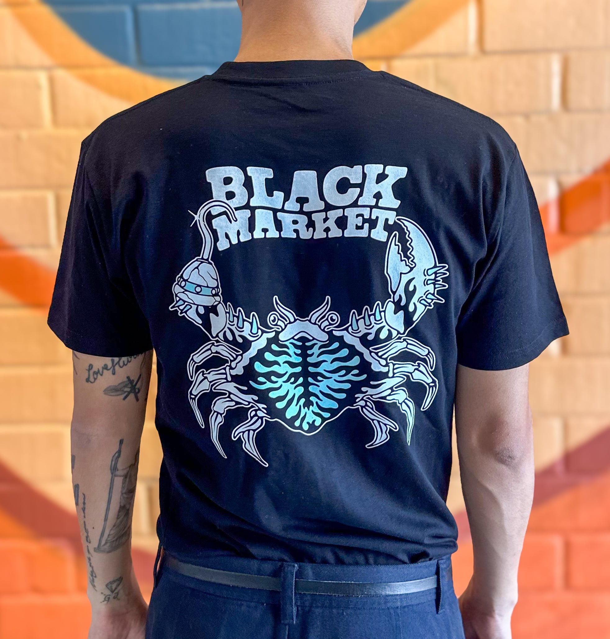 Lifestyle photo of Black Market Crab T-Shirt being worn - coffee culture apparel