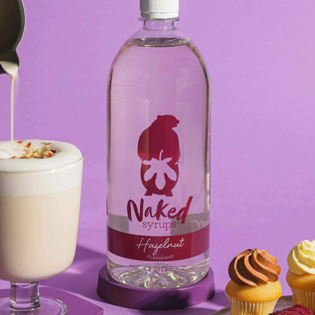 Bottle of Naked syrups next to cupcakes by Black Market Coffee